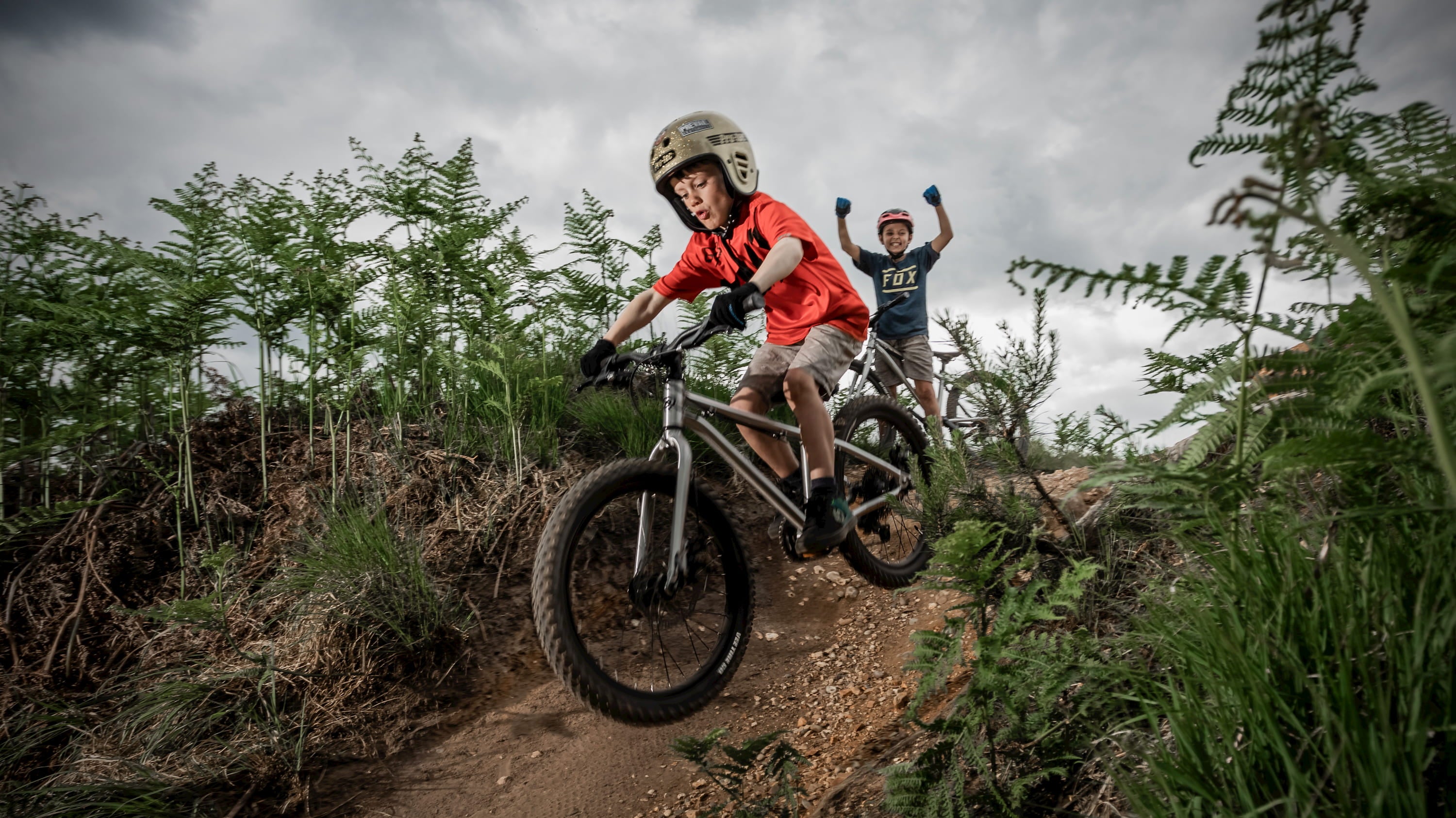 Kid riding Seeker 20 along a forest trail