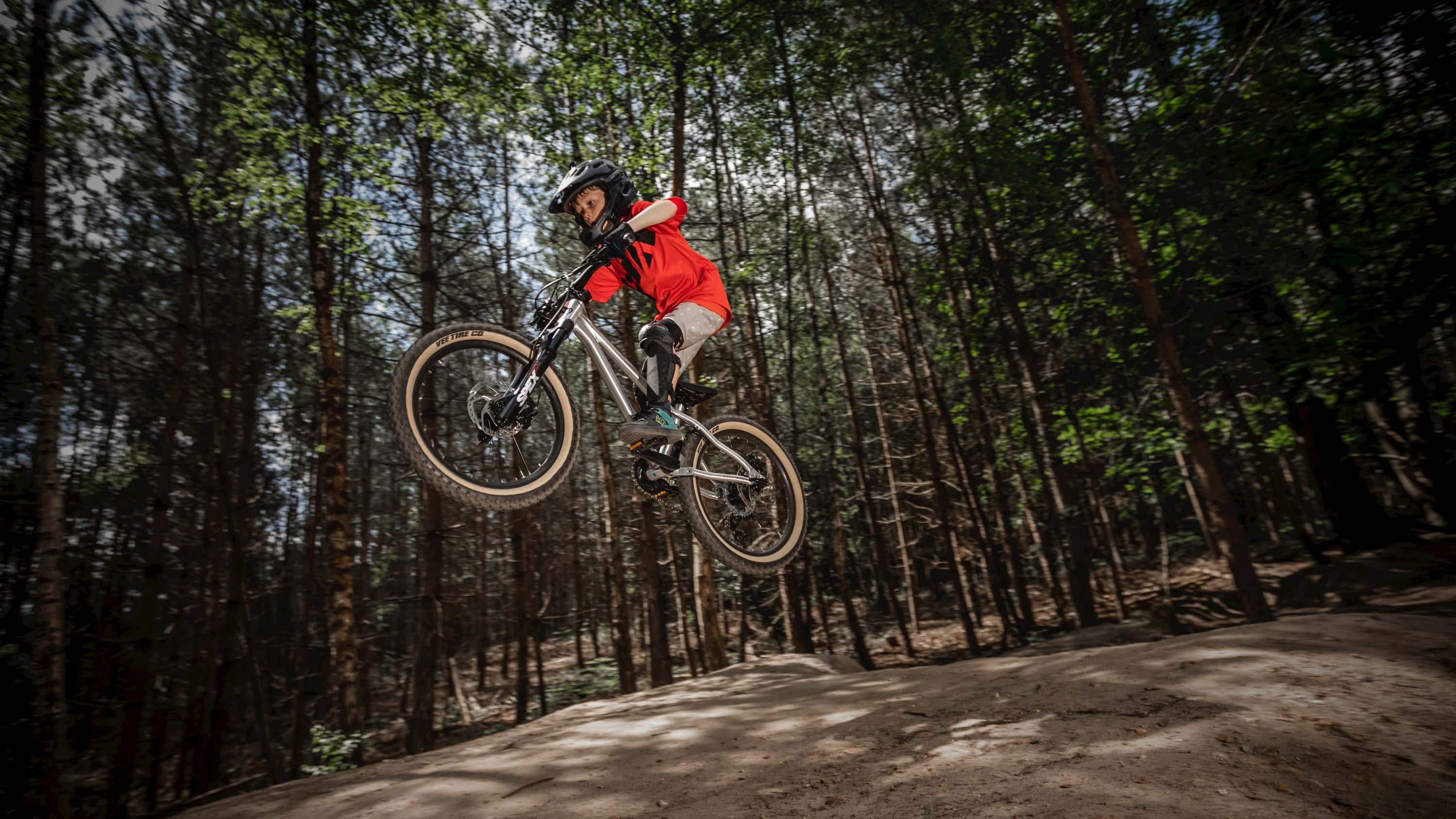 Kid performing a jump on a Hellion 20 bike