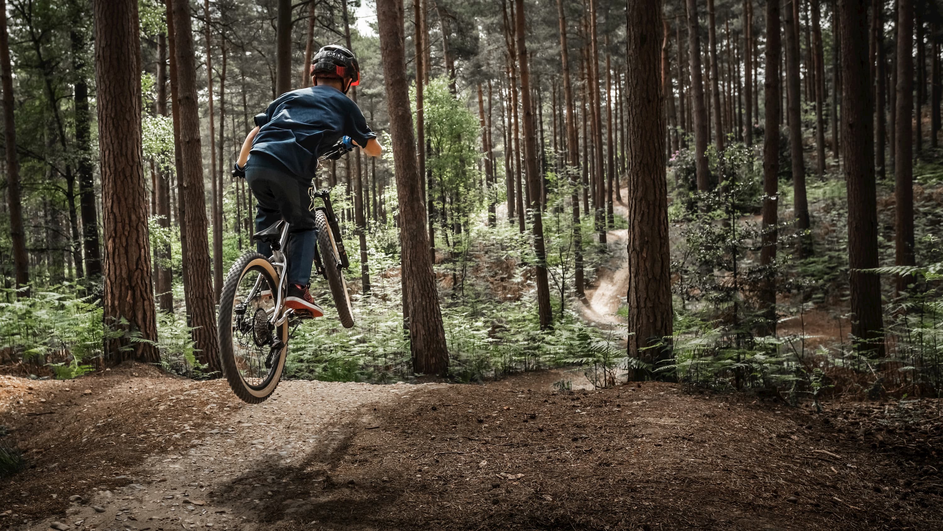 Hellion 24 bike being ridden at a trail centre